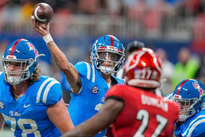 Matt Corral throwing a football for Rebel touchdown
